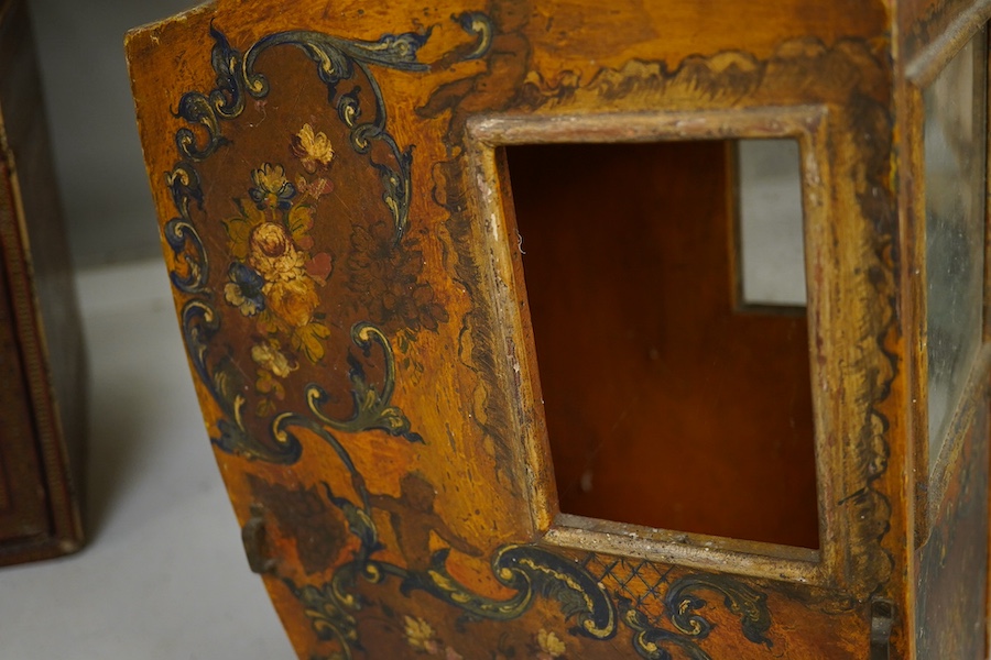 A Venetian painted wooden model of a sedan chair, probably designed for a doll, 36cm high. Condition - some crazing to the painted cartouche decoration, gilt worn, One glass panel missing